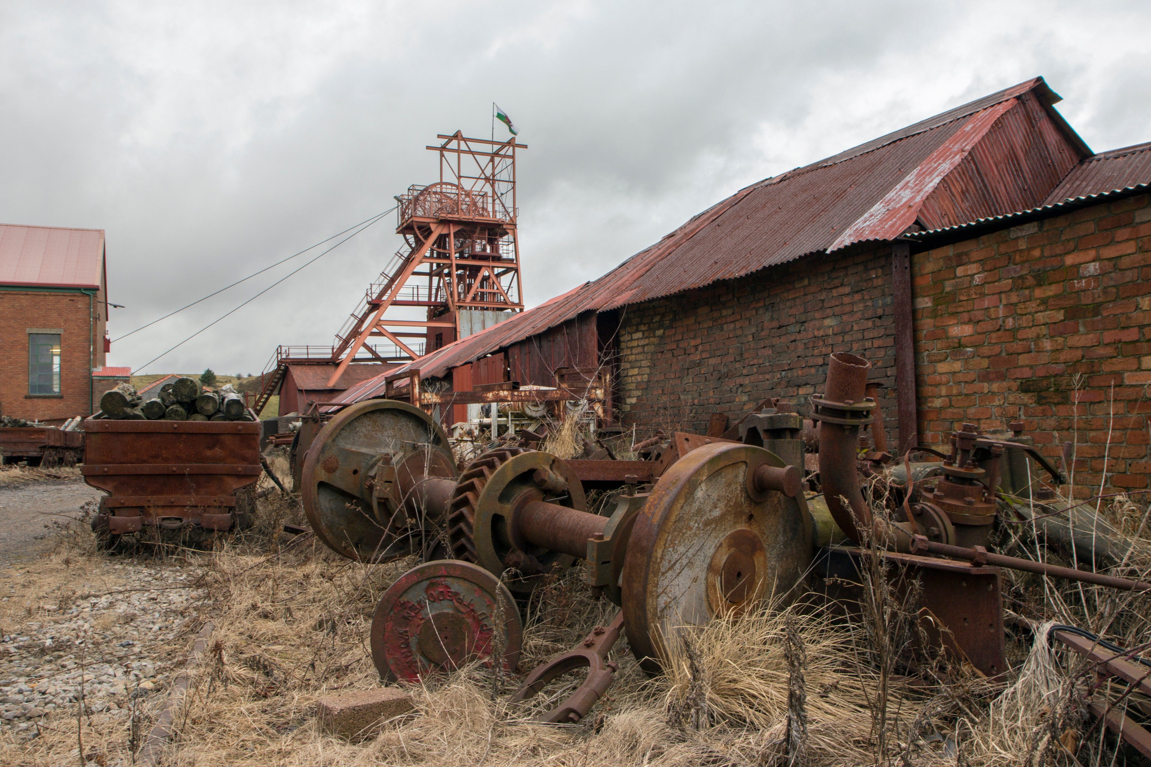 Abandoned mining equipment and buildings under a cloudy sky