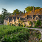 Row of traditional houses with a stream in the foreground